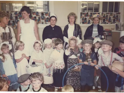 Staff and kids in Victorian outfits, 1980s?
